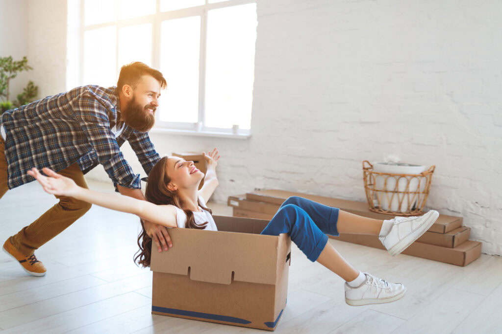 Happy Young Married Couple Moves To New Apartment